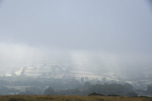 Atmospheric autumn mist over widecombe-in-the-Moor on Dartmoor